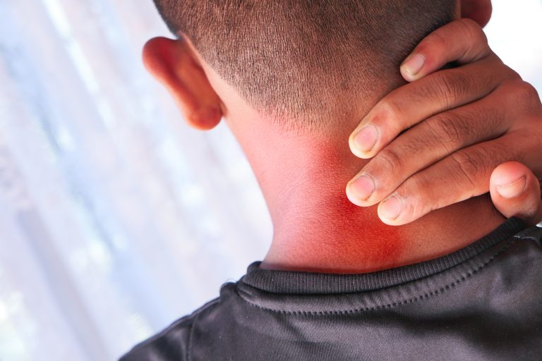 Chiropractic for Headaches and Migraines Camrose 2 Man holding his neck due to neck pain before visiting a physiotherapy clinic