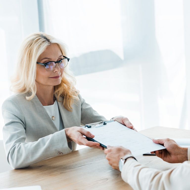 professional woman passing document to colleague a 2026 01 05 23 44 33 utc